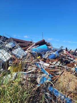 Pile of Mixed Scrap Metal Under Clear Blue Sky