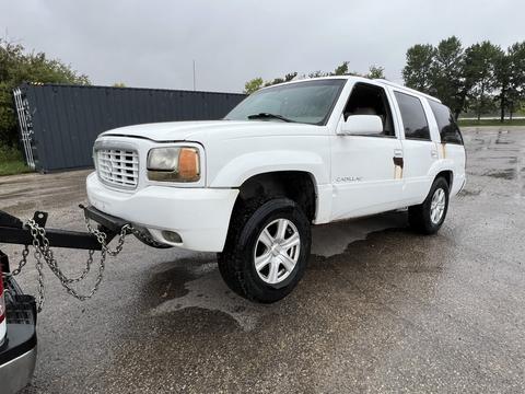 Towing a White SUV for Scrap Metal Recycling