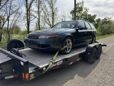 Old Car Loaded on Trailer for Scrap Metal Recycling
