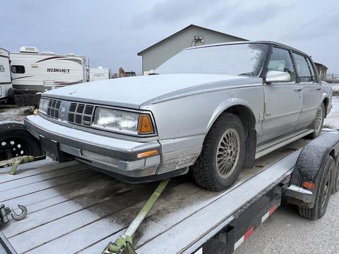 Old Sedan Secured on Trailer for Scrap Metal Recycling
