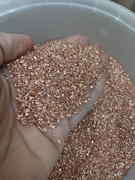Hand Holding Shiny Copper Scrap for Recycling